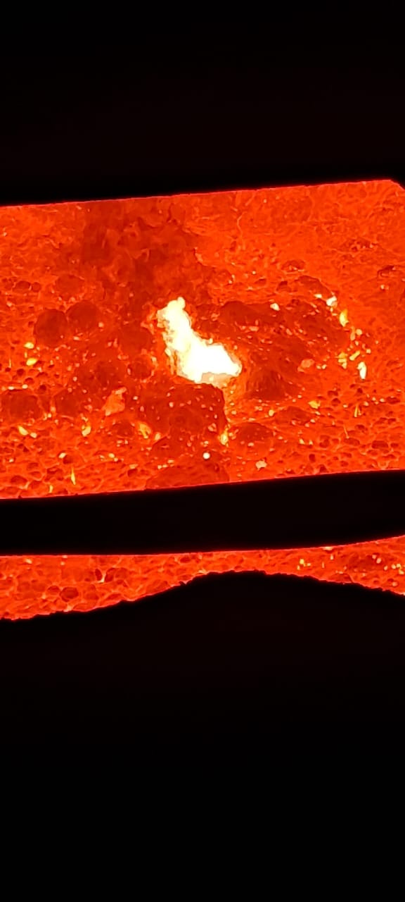 Molten steel through refractory taphole — in operation